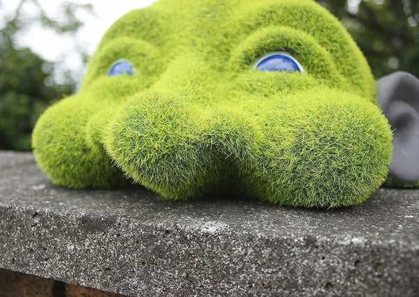 Novelty head sculpture displayed in garden