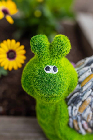 Resin snail decoration displayed in garden rockery