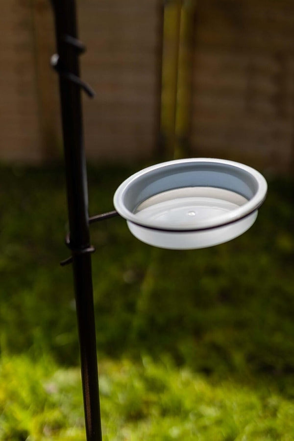 Bird feeding station with water dish