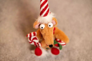 Gingerbread inspired rat decoration displayed on a shelf