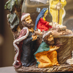 Christmas snow globe displayed on mantelpiece