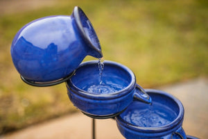 Solar powered blue water feature displayed on a patio