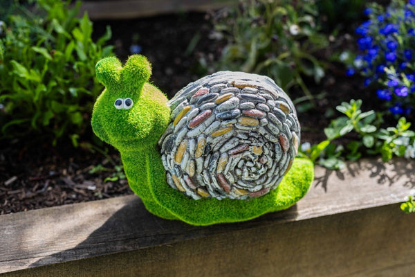 Grass effect resin snail displayed on lawn