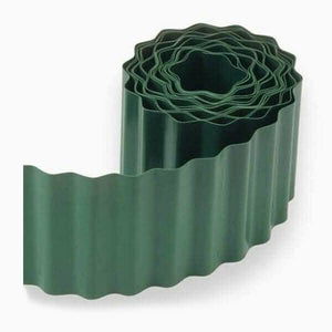 Green plastic wavy lawn edging roll in garden border