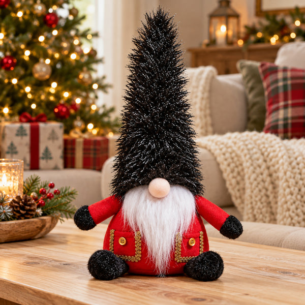 A festive Christmas gnome decoration sitting on a wooden table in a cozy living room setting, with a lit Christmas tree and holiday decorations in the background.
