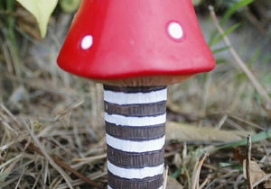 Poly resin mushrooms positioned among green plants