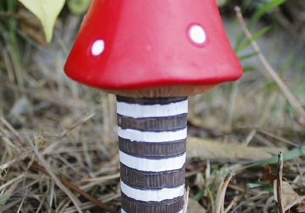 Poly resin mushrooms positioned among green plants
