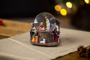 Nativity ornament with decorative swirling glitter