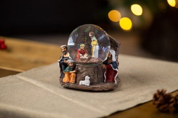 Nativity ornament with decorative swirling glitter