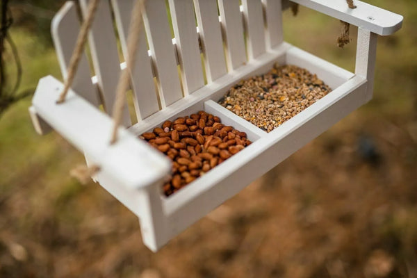 Wooden swing feeder designed for small garden birds