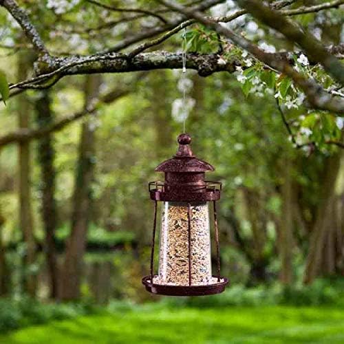Decorative lighthouse lantern bird feeder hanging outdoors
