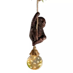Climbing sloth solar ornament displayed outdoors