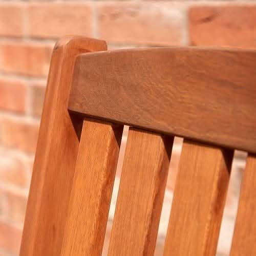 Wooden companion bench positioned beside garden plants