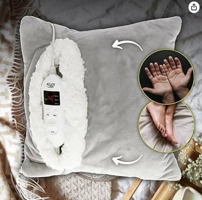 Electric heated pillow displayed on sofa