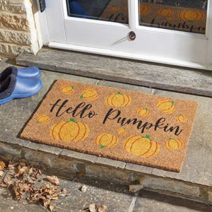 Doormat with pumpkins and 'Hello Pumpkin' text on a stone step.
