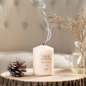 White scented candle in glass container