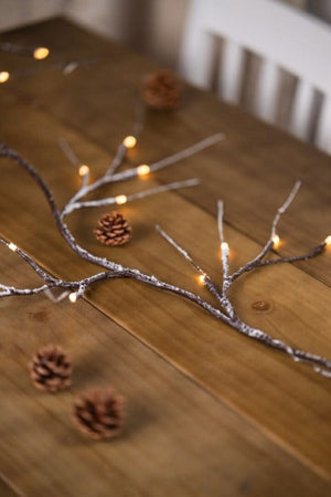 Illuminated branch garland styled along a staircase