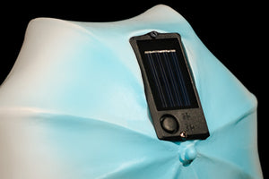 Solar umbrella ornament displayed amongst garden plants