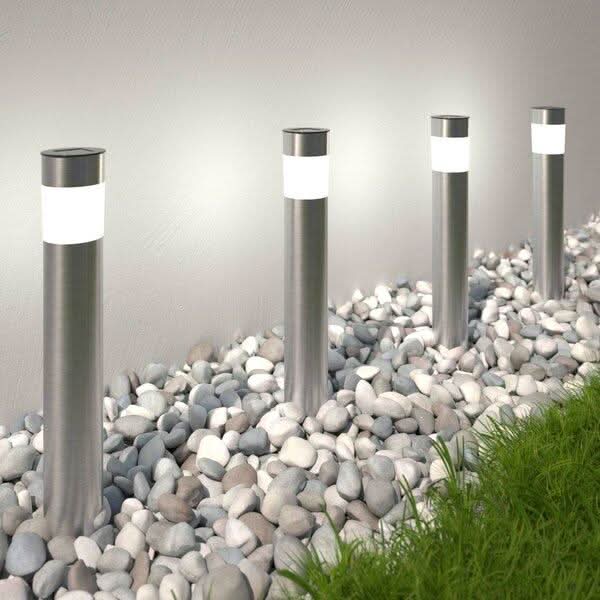 Solar bollard pathway lights illuminating garden walkway