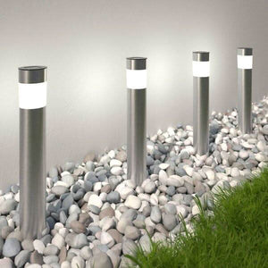 Solar bollard pathway lights illuminating garden walkway