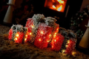 Three sparkly present decorations with warm white lighting