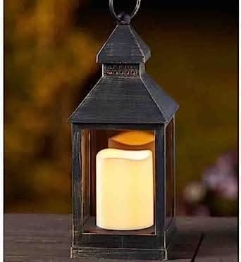 Decorative lantern displayed on outdoor patio table