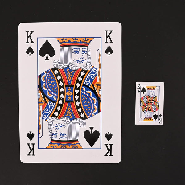 Oversized playing cards displayed inside a storage box.