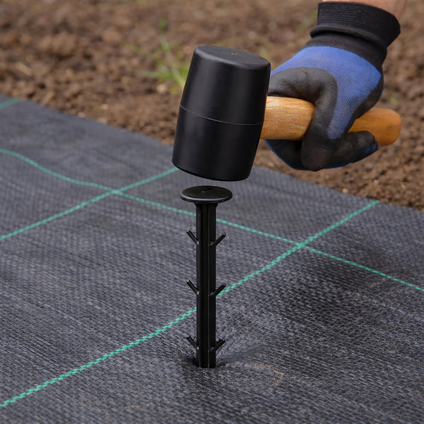 Black garden pegs securing weed control membrane