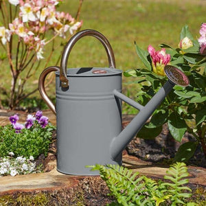 Nine litre galvanised steel watering can shown outdoors