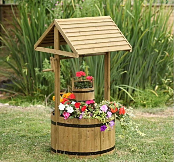 Large wooden wishing well planter with rustic barrel base.