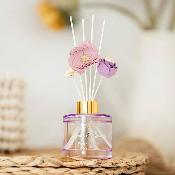 Decorative diffuser with floral elements on a blurred background