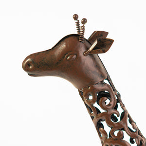 Metal giraffe garden ornament illuminated after dark