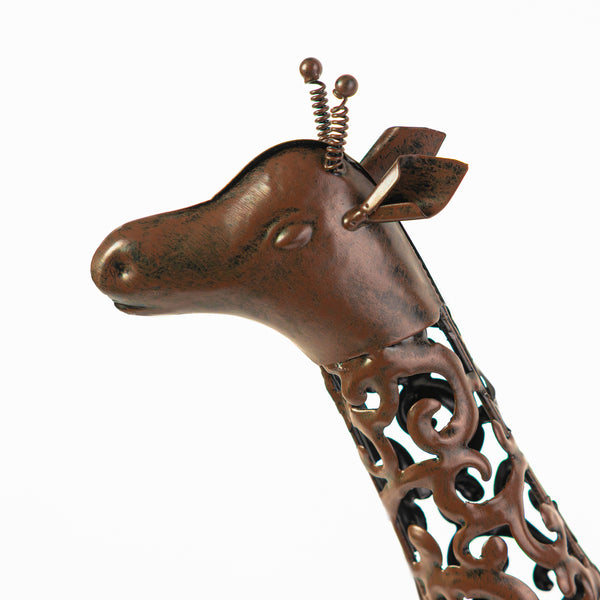 Metal giraffe garden ornament illuminated after dark