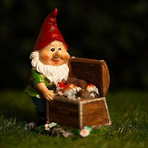 Colourful gnome light positioned beside a garden pathway