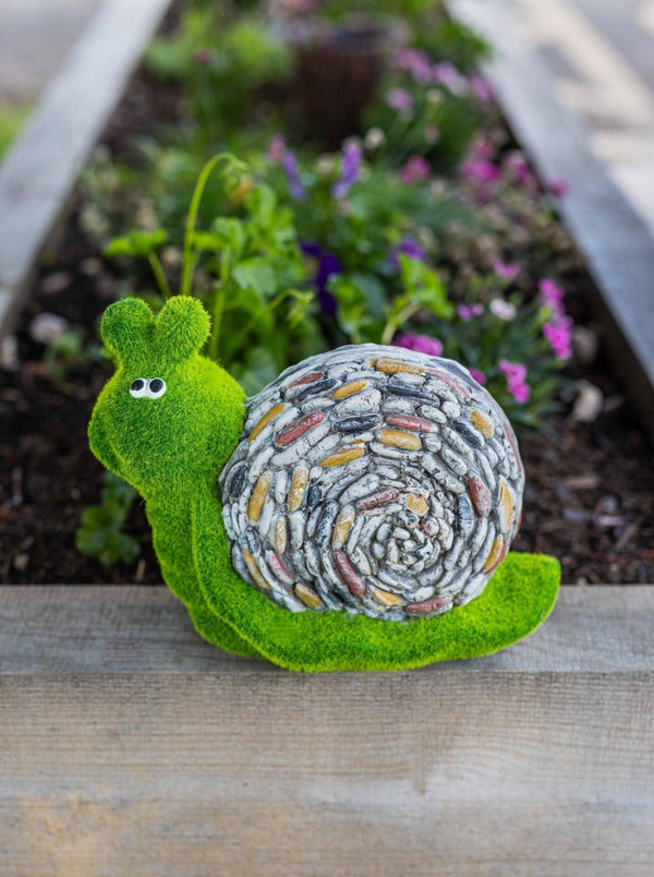 Stone effect snail garden statue shown close up