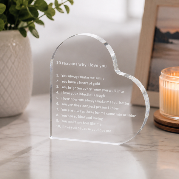 Freestanding clear acrylic heart displayed on a desk
