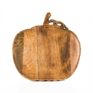 Wooden pumpkin board displayed on an autumn table