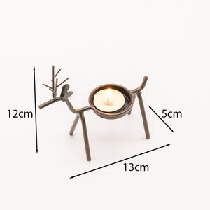 Reindeer tea light decorations arranged with Christmas décor