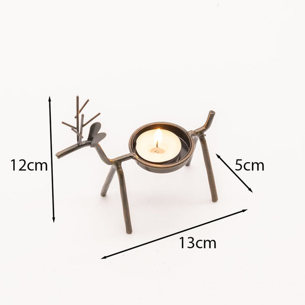 Reindeer tea light decorations arranged with Christmas décor