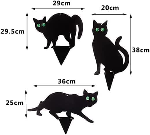 Metal cat garden pest deterrent stakes in flower bed