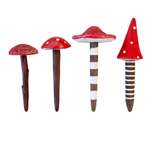 Four miniature red toadstools in assorted sizes