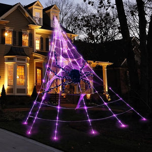 Decorative spider web with purple lights in front of a house