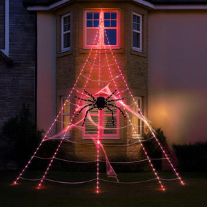 Halloween-themed LED spider web and spider decoration in front of a house window.