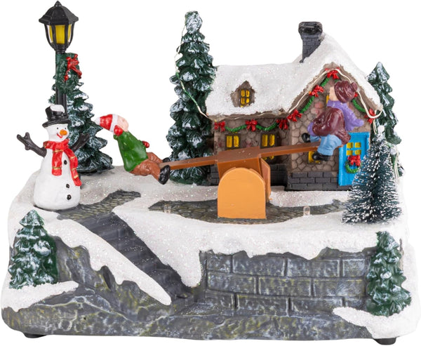 Christmas village decoration with animated see-saw figures