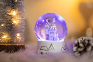 Musical LED snow globe displayed on festive table