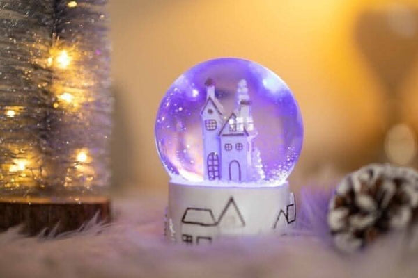 Musical LED snow globe displayed on festive table