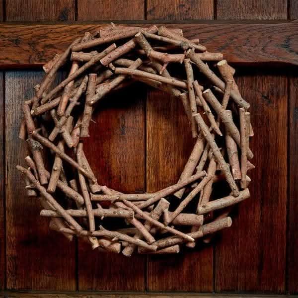 Natural wood autumn wreath displayed on a front door