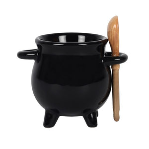 Black ceramic cauldron with a wooden spoon on a white background