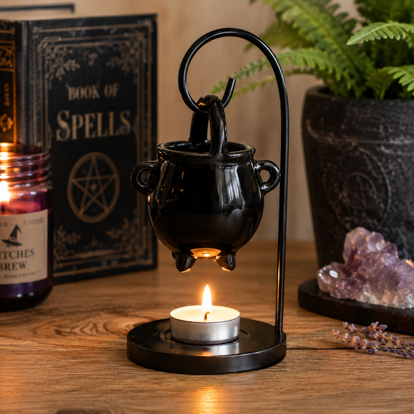 Decorative cauldron oil burner arranged on a side table