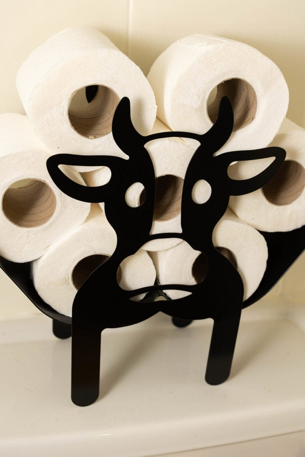 Novelty cow toilet roll holder in black metal